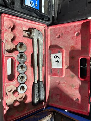 a red case with tools inside of it on a table