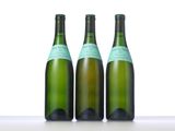 three bottles of wine that are sitting on a table