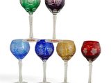 several different colored wine glasses sitting on top of each other