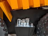 a close up of a yellow dump truck with a bunch of tires