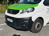 a white van with a green and black stripe parked in a parking lot