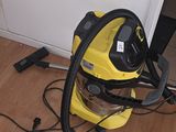 a yellow and black vacuum on the floor next to a door