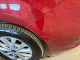 a close up of a red car with a black rim