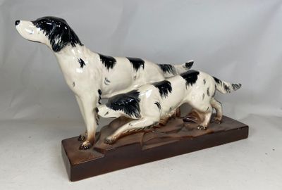 a statue of a dog and a cat on a wooden base