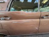 a brown car that is parked on the side of the street