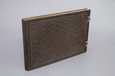 brown leather book with gold trim on a white background
