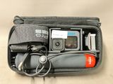 a bag with a camera and other items in it
