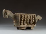 an ancient stone sculpture of a turtle with figures on it