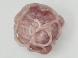 a pink object on a white surface that looks like a flower