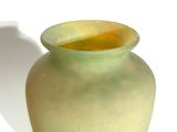 a vase that is sitting on a table with a shadow on it