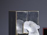 a close up of a bottle of perfume next to a box of perfume