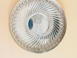 a silver plate with a circular design on it