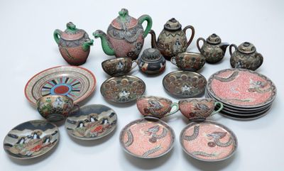 many pieces of pottery sitting on a white surface