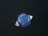an image of a blue stone ring on a black surface