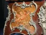a small table with a painting on the top of it