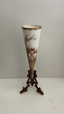 a vase that is sitting on a stand on a table