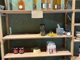 a wooden shelf with many different types of honeys on it