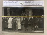 an old photo of a group of people standing in front of a store