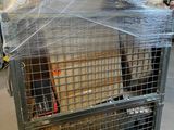 a large metal cage with a bunch of boxes in it