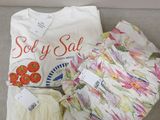a white t - shirt and some other items on a couch