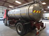 a large tanker truck parked inside of a building