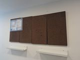a picture of a room with a bulletin board on the wall