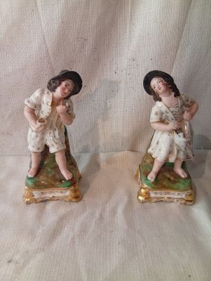 deux figurines d'un homme et d'une femme assis sur un banc