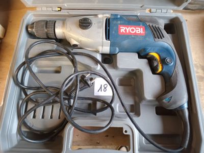 a corded drill in a tool box with wires in it