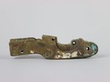 a metal object that looks like a shoe on a white surface