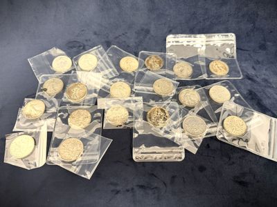 some gold coins in plastic bags on a blue surface