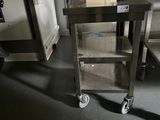 a metal cart that is sitting in the middle of a room
