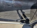 a shadow of a person standing in front of a car