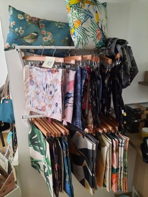 a rack with many different types of fabric hanging on it
