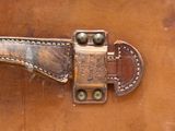 a close up of a brown leather suitcase with a latch