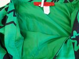 the back of a green jacket with black and white designs