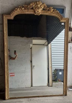 a man taking a picture of a mirror in a room