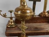 three candles and a cross on a wooden stand