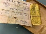a piece of gold on a piece of paper on a table