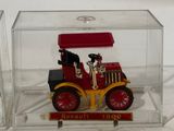 a red and yellow toy truck in a clear box