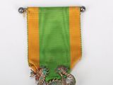 a green and yellow ribbon with a silver medal on it