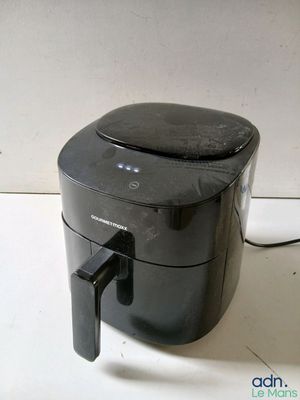 a black air fryer sitting on a counter top