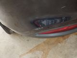 a close up of a car ' s tail light on the side of the car