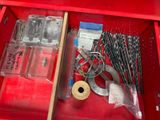 a red tool box with tools in it and a roll of tape