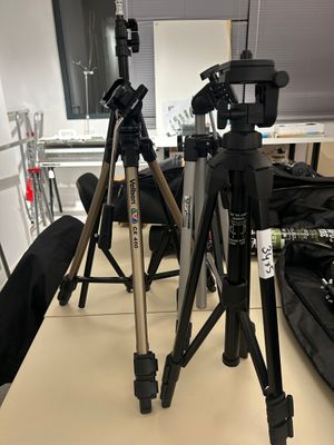 two tripods that are sitting on a table in a room