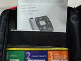 a red suitcase with a black handle and a paper in it