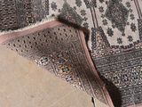 a cat that is laying on a rug on the floor
