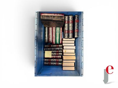 a blue box filled with books on top of a white surface