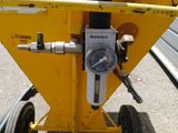 a close up of a yellow machine with a gauge on it