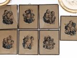 several framed pictures of people and a clock on a wall