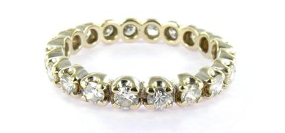a yellow gold ring with diamonds on a white background
